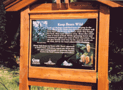 bear smart interpretive sign in wooden kiosk